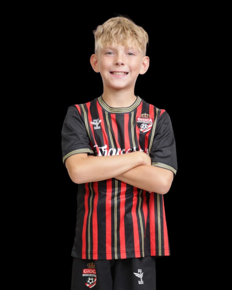 Young Gioca player smiling in the academy kit