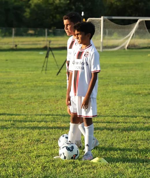 Young players listening and learning together at soccer training