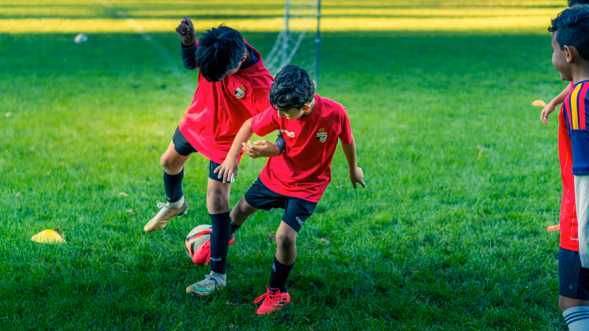 A Gioca player protecting the ball from a teammate during a duel at training